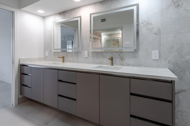 bathroom with vanity and tile walls