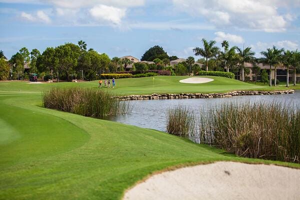 surrounding community with a water view and a yard