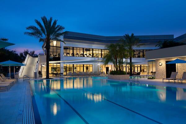 pool at dusk featuring a patio