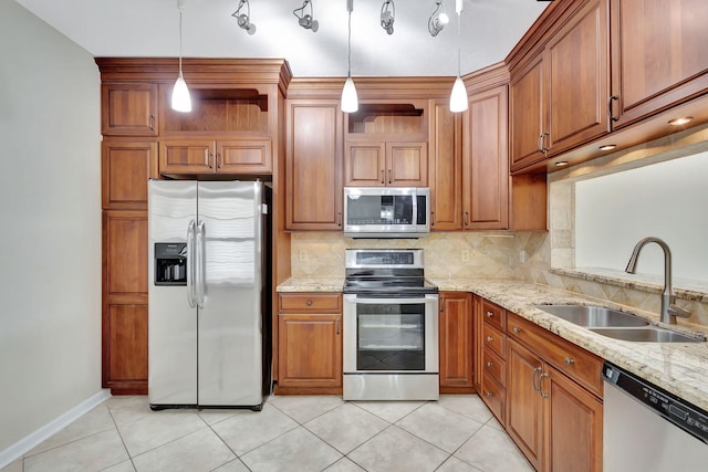 kitchen with backsplash, stainless steel appliances, sink, light tile patterned floors, and hanging light fixtures