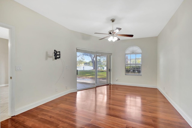 spare room with wood-type flooring and ceiling fan