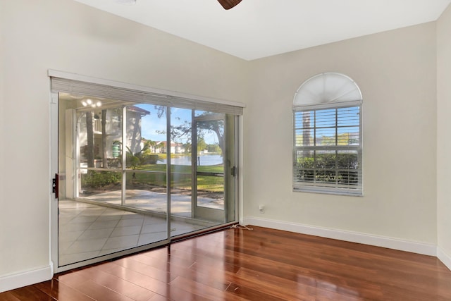 empty room with ceiling fan and wood-type flooring