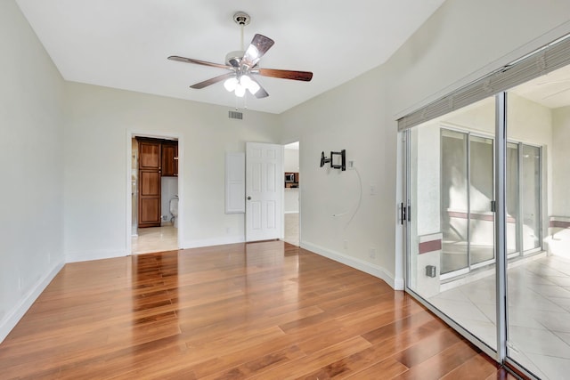 spare room featuring light hardwood / wood-style floors and ceiling fan