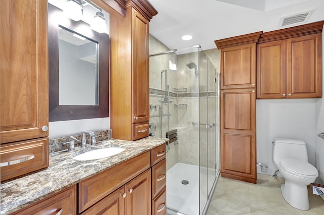 bathroom featuring vanity, toilet, and a shower with door