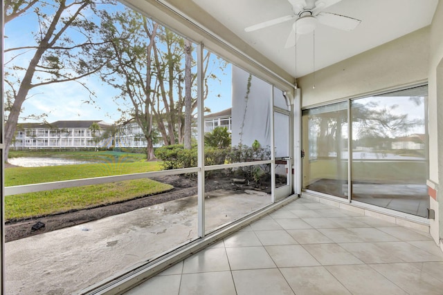 unfurnished sunroom with ceiling fan