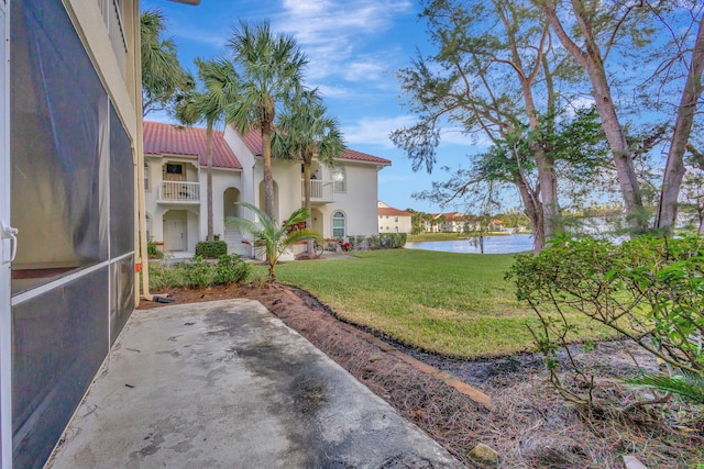 view of yard featuring a balcony and a water view