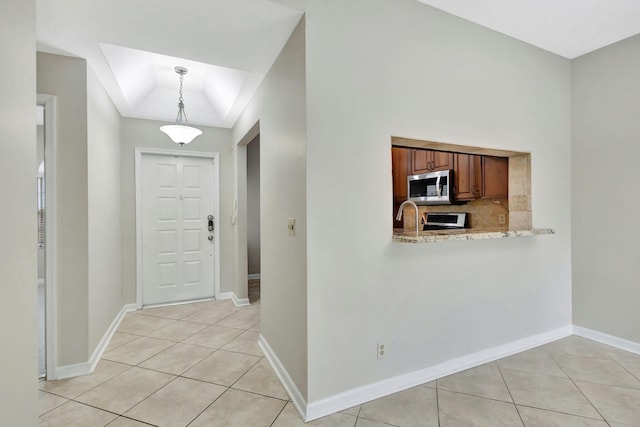 tiled foyer with lofted ceiling