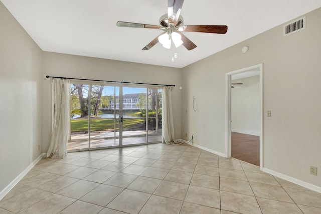 tiled spare room with ceiling fan