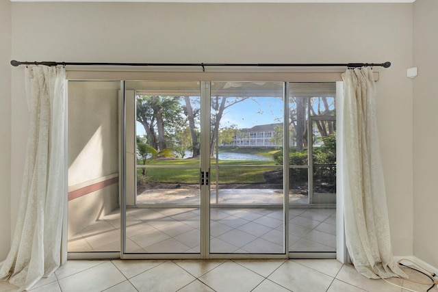 entryway with a water view and light tile patterned floors