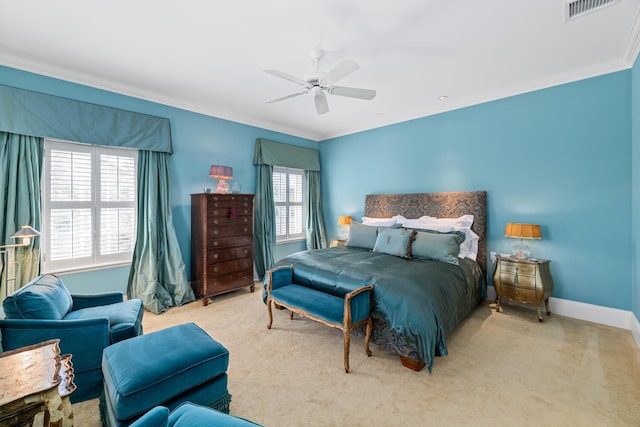 carpeted bedroom with ceiling fan and crown molding