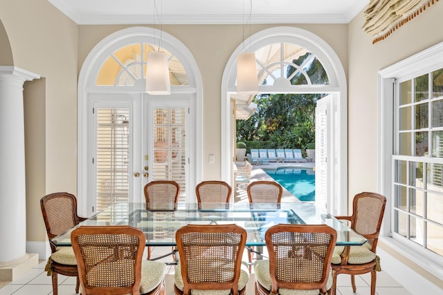 dining area with light tile patterned flooring, ornate columns, and ornamental molding