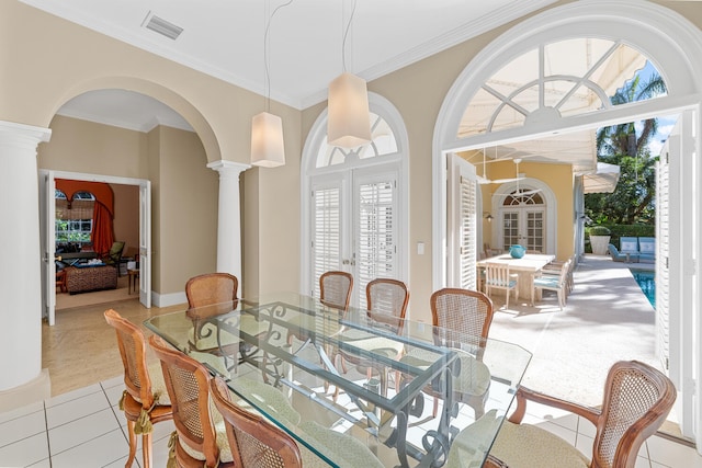 dining space featuring ornate columns, crown molding, and french doors