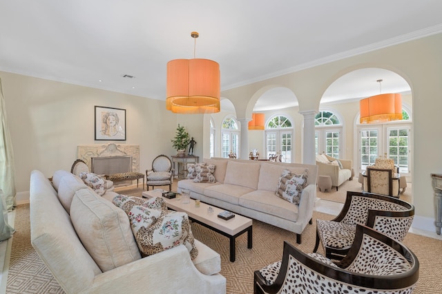 living room featuring ornate columns, a premium fireplace, crown molding, and light carpet