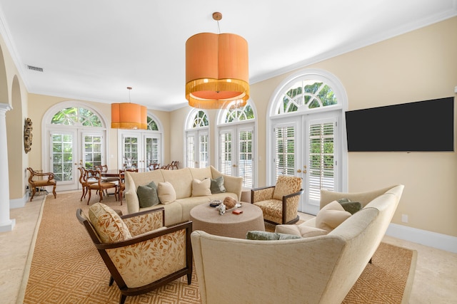 living room featuring french doors, crown molding, and a healthy amount of sunlight