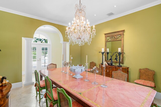 dining room featuring a chandelier, ornate columns, crown molding, and french doors