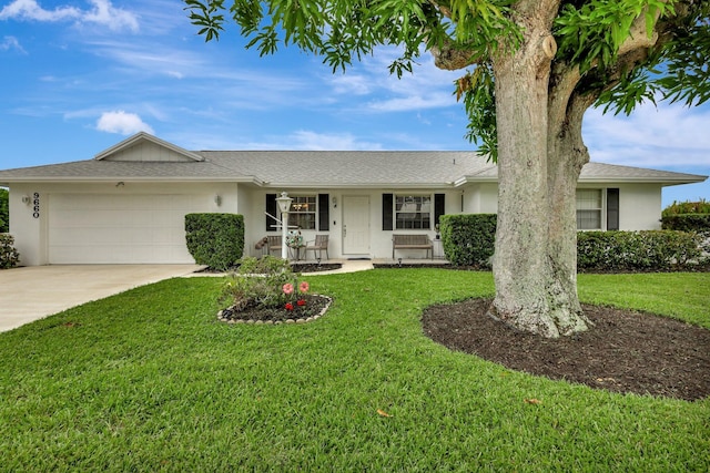 single story home with a porch, a garage, and a front lawn