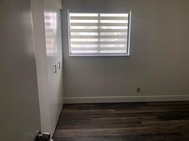 spare room featuring dark hardwood / wood-style flooring