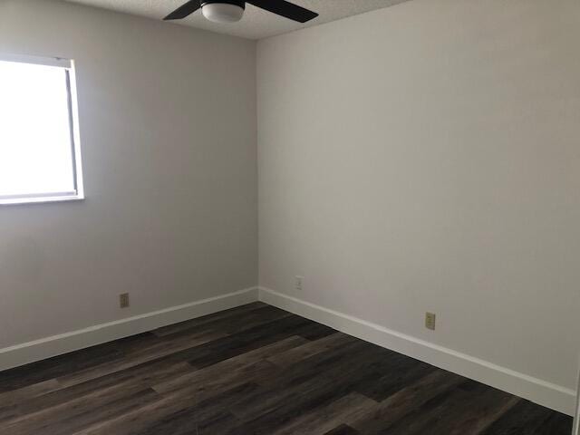 7630 Lago Del Mar Dr Unit 1, Boca Raton, FL 33433 - unfurnished room featuring a ceiling fan and dark wood-type flooring
