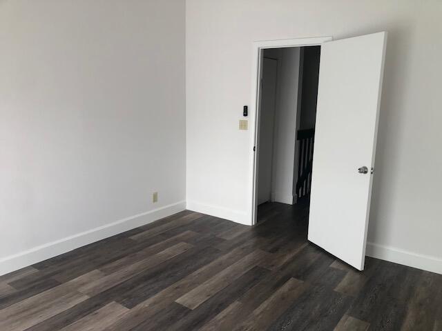 empty room featuring dark hardwood / wood-style flooring