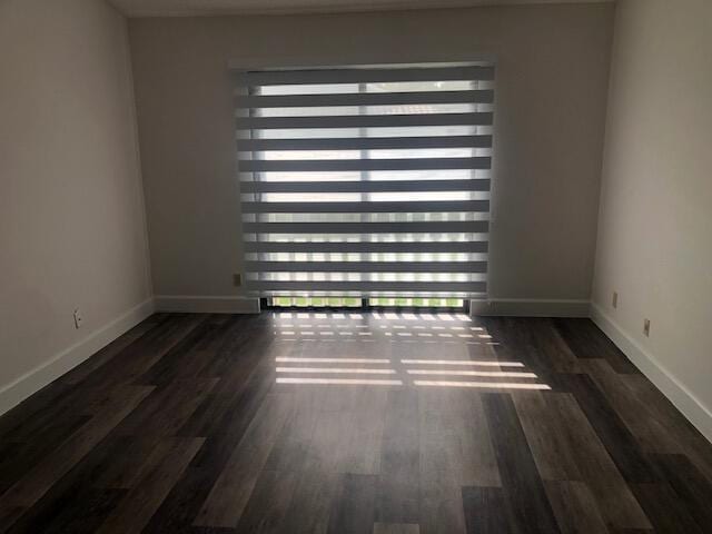 spare room featuring dark hardwood / wood-style floors