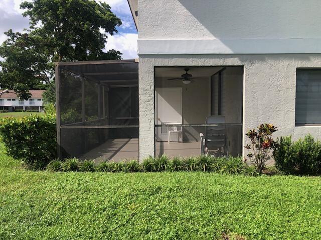 rear view of property featuring a yard