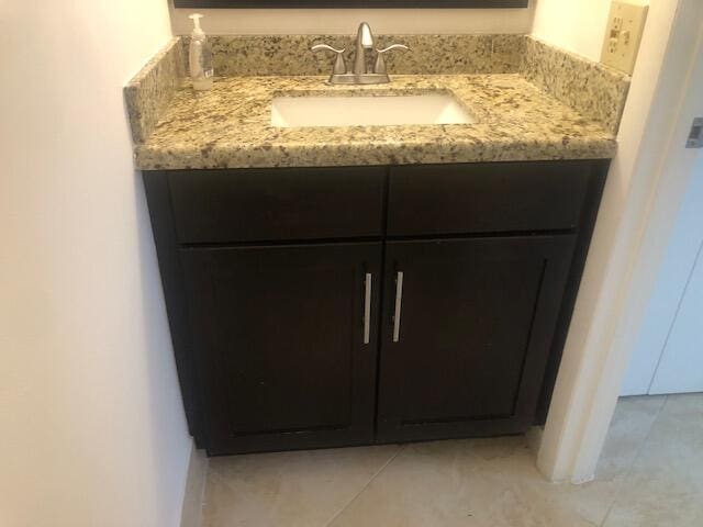 bathroom featuring tile patterned flooring and vanity