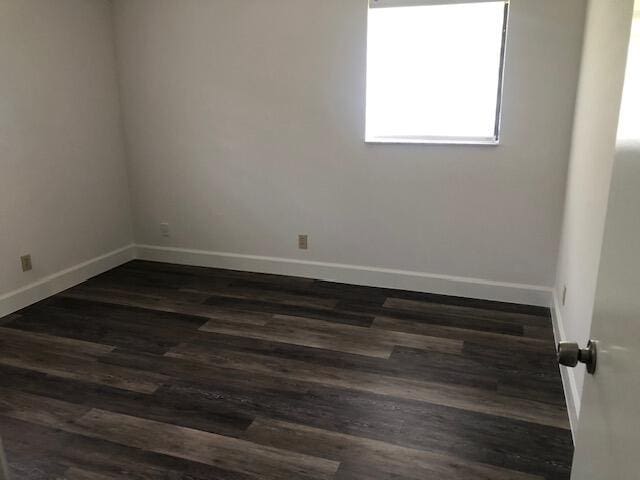 7630 Lago Del Mar Dr Unit 1, Boca Raton, FL 33433 - unfurnished room featuring baseboards and dark wood-style flooring