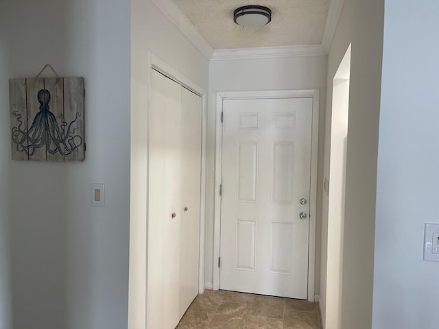 corridor featuring ornamental molding and a textured ceiling