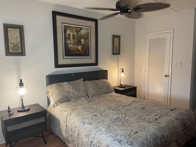 bedroom featuring hardwood / wood-style floors, a textured ceiling, a closet, and ceiling fan