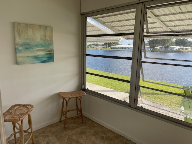 sunroom / solarium featuring a water view