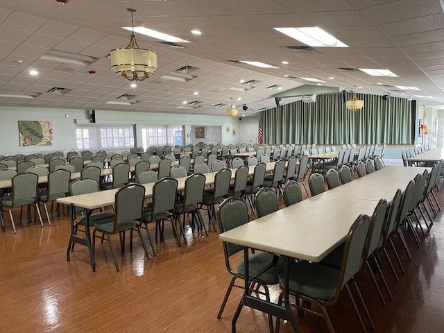 dining area featuring hardwood / wood-style floors and a paneled ceiling