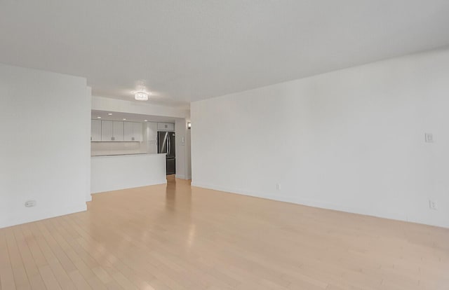 unfurnished living room featuring light wood-type flooring