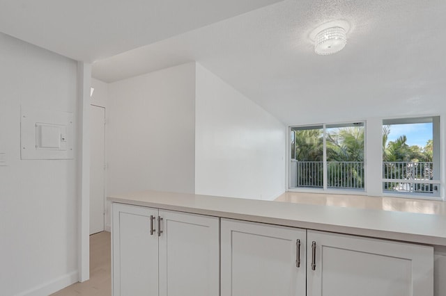 interior space with white cabinetry and a textured ceiling