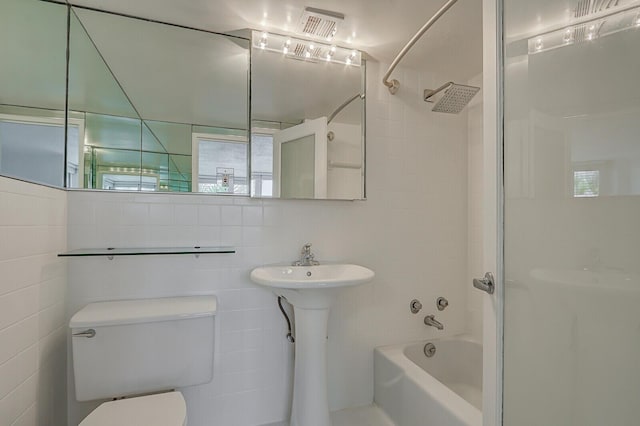 full bathroom with shower / tub combination, toilet, tile walls, and sink