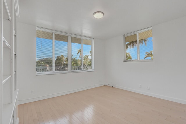 empty room with light hardwood / wood-style flooring