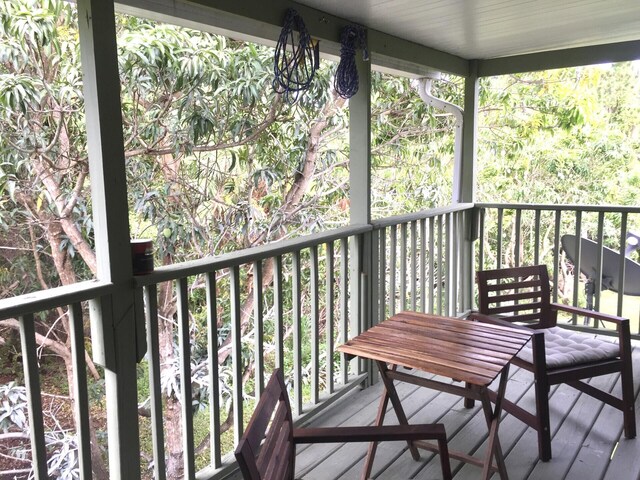 unfurnished sunroom with a wall mounted air conditioner