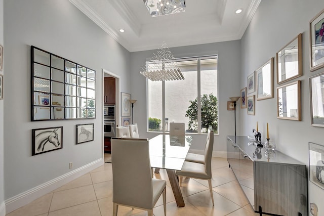 tiled dining room featuring an inviting chandelier and crown molding