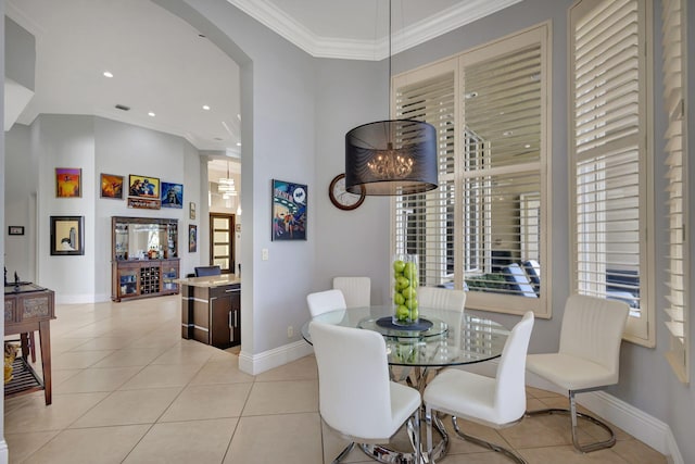 tiled dining room featuring ornamental molding