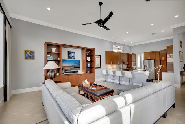 tiled living room featuring ceiling fan and crown molding