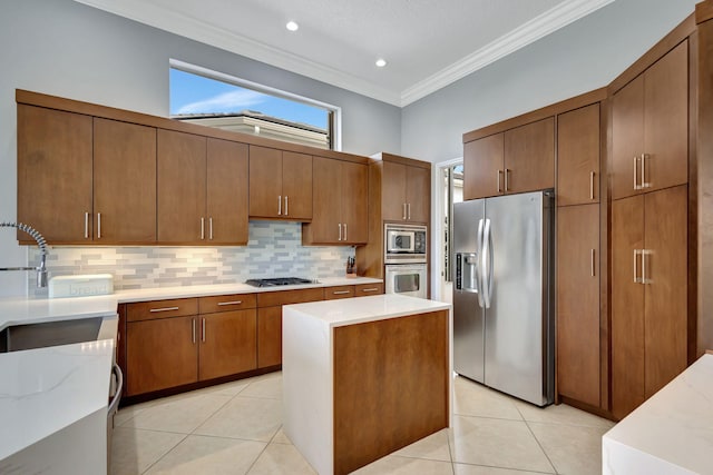 kitchen with light tile patterned floors, stainless steel appliances, ornamental molding, and sink