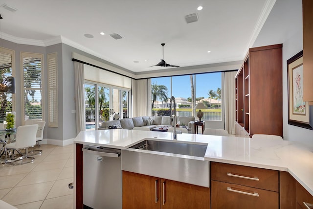 kitchen featuring stainless steel dishwasher, a healthy amount of sunlight, and crown molding