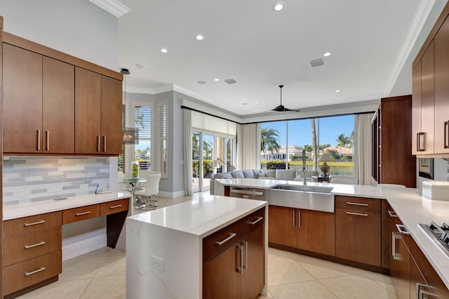 kitchen featuring a healthy amount of sunlight, tasteful backsplash, ceiling fan, and ornamental molding