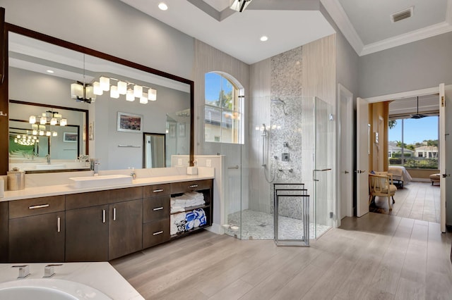 bathroom featuring crown molding, vanity, an enclosed shower, and hardwood / wood-style flooring