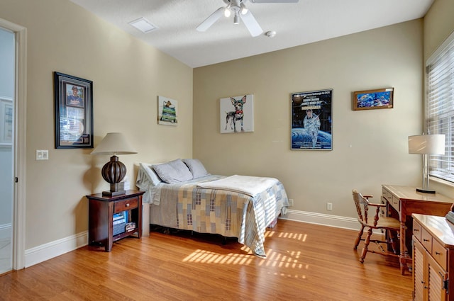 bedroom with ceiling fan and light hardwood / wood-style floors