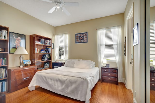 bedroom with ceiling fan and light hardwood / wood-style floors