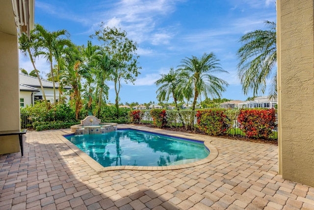 view of swimming pool featuring an in ground hot tub and a patio