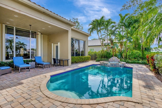 view of swimming pool featuring an in ground hot tub and a patio