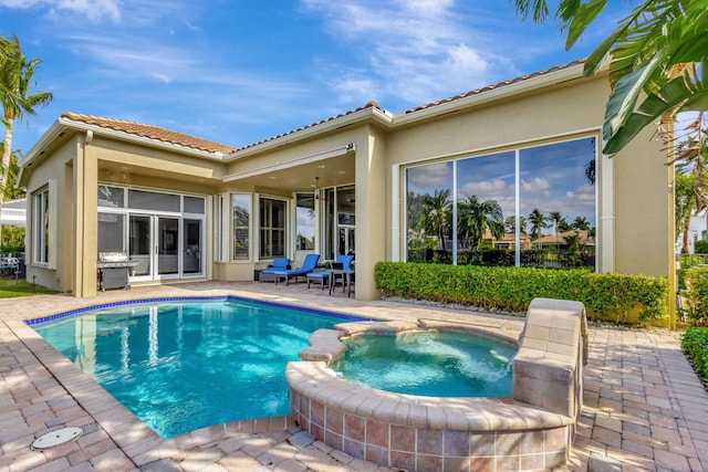 view of swimming pool with a patio area and an in ground hot tub