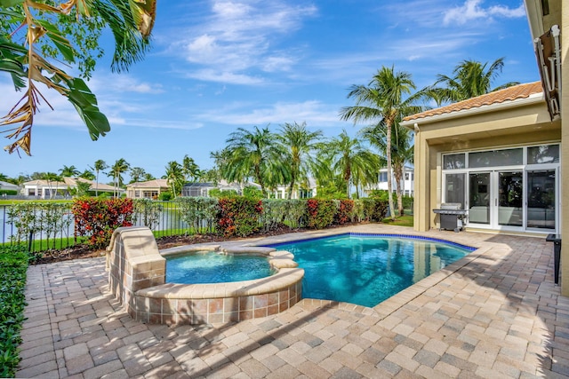 view of swimming pool featuring an in ground hot tub, french doors, and a patio