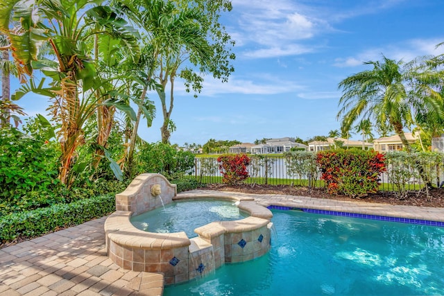 view of swimming pool with pool water feature